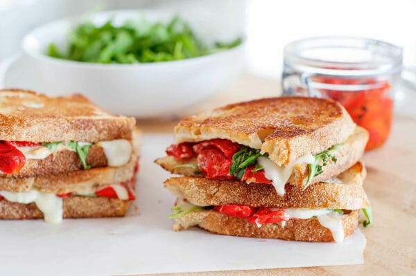 Ready to try a new kind of grilled cheese? This Grilled Cheese with Mozzarella, Roasted Red Peppers, and Arugula is sweet, peppery, and too tempting to pass up!